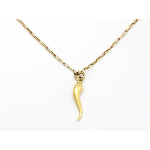 771 - A yellow metal pendant formed as an Italian twisted horn, on a 9ct gold chain. Pendant approx. 1