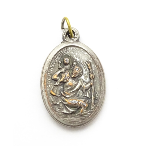 773 - A silver plate pendant of oval form depicting Mary, St Christopher, etc. Approx. 1