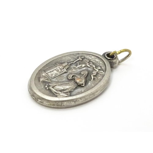 773 - A silver plate pendant of oval form depicting Mary, St Christopher, etc. Approx. 1