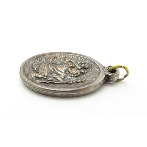 773 - A silver plate pendant of oval form depicting Mary, St Christopher, etc. Approx. 1