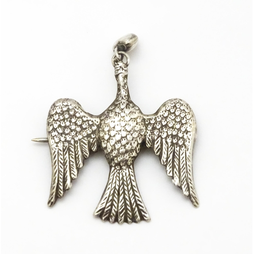 774 - A white metal sweetheart brooch formed as a bird / dove with heart drop to beak1 1/2