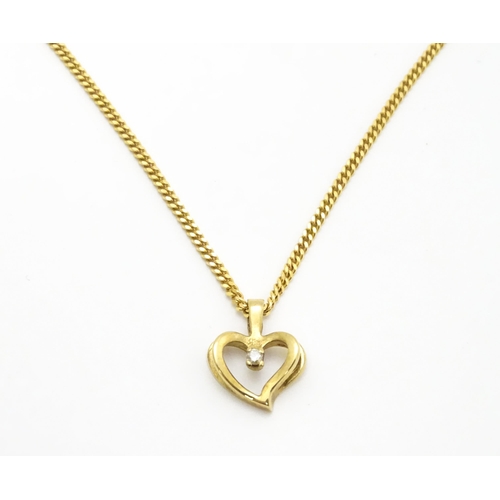 777 - A 9ct gold necklace with 9ct gold pendant of heart form set with central diamond. Chain approx. 18