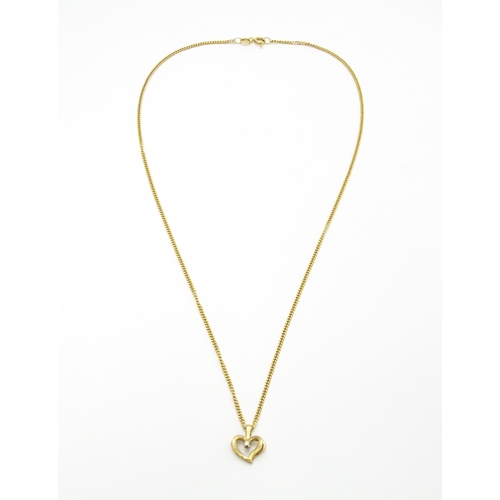 777 - A 9ct gold necklace with 9ct gold pendant of heart form set with central diamond. Chain approx. 18