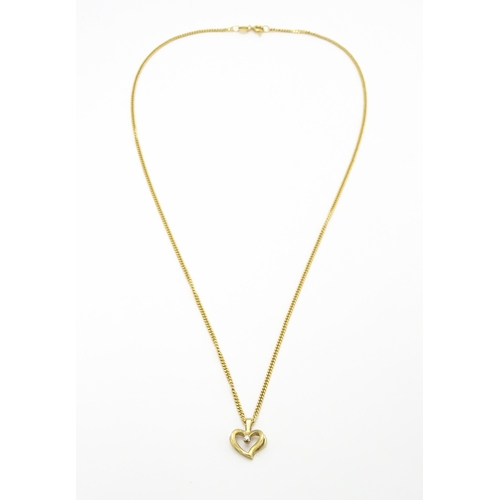 777 - A 9ct gold necklace with 9ct gold pendant of heart form set with central diamond. Chain approx. 18