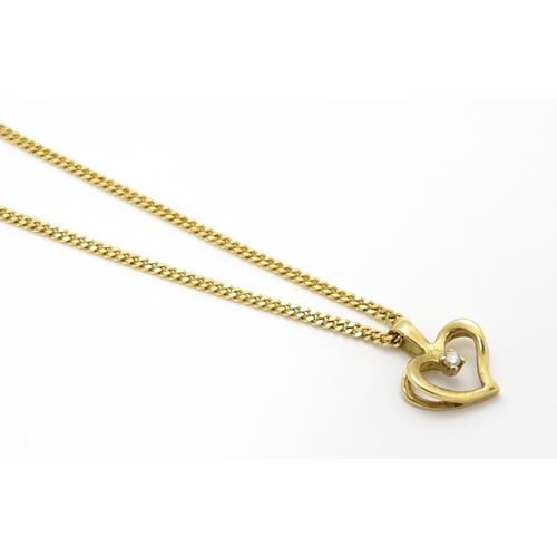 777 - A 9ct gold necklace with 9ct gold pendant of heart form set with central diamond. Chain approx. 18