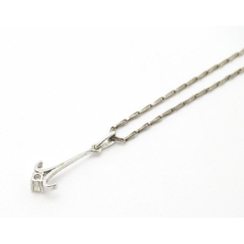 778 - A 9ct white gold pendant set with white stone detail. On a silver chain. Pendant approx. 1