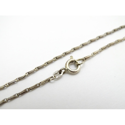 778 - A 9ct white gold pendant set with white stone detail. On a silver chain. Pendant approx. 1