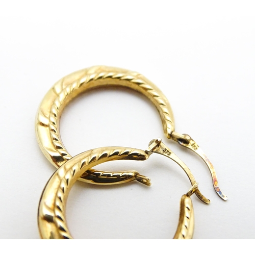 848A - A pair of 9ct gold hoop earrings. Approx 3/4