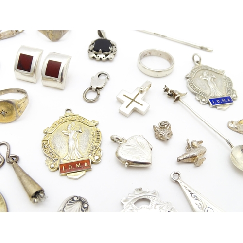 902A - A quantity of silver items to include pendants, earrings, rings, charms, salt spoon, etc. To include... 