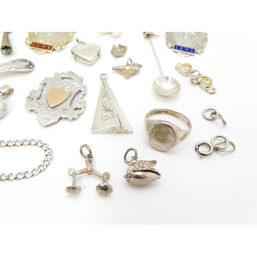 902A - A quantity of silver items to include pendants, earrings, rings, charms, salt spoon, etc. To include... 