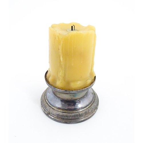 1098 - A 20thC French novelty table lighter modelled as a candle with a silver plate base. Marked under Bri... 