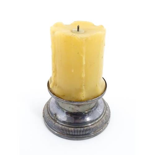 1098 - A 20thC French novelty table lighter modelled as a candle with a silver plate base. Marked under Bri... 