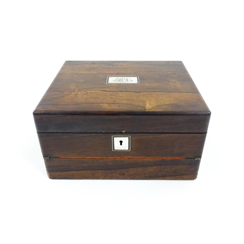 1286 - A Victorian rosewood workbox with inlaid mother of pearl escutcheon and plaque to top, opening to re... 