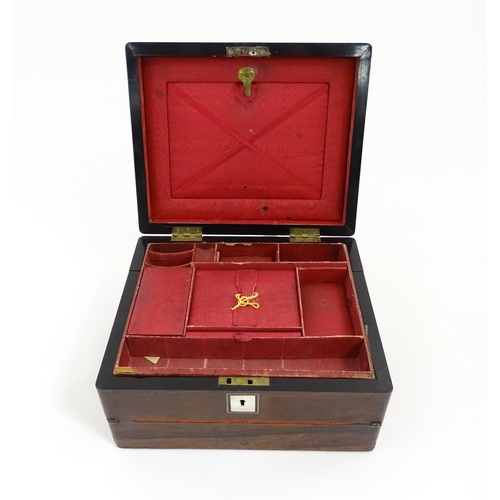 1286 - A Victorian rosewood workbox with inlaid mother of pearl escutcheon and plaque to top, opening to re... 