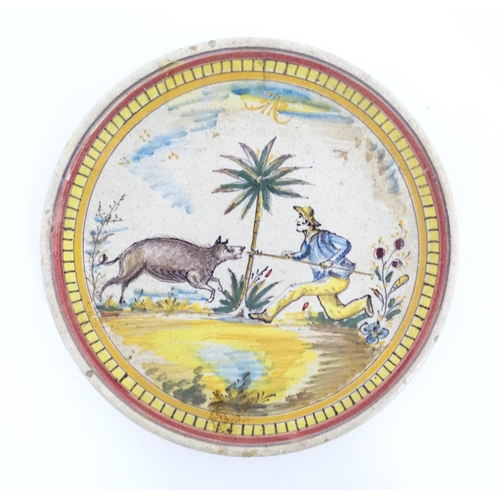 199 - Two Continental tin glazed earthenware plates one depicting a boar hunt, the other a man on horsebac... 