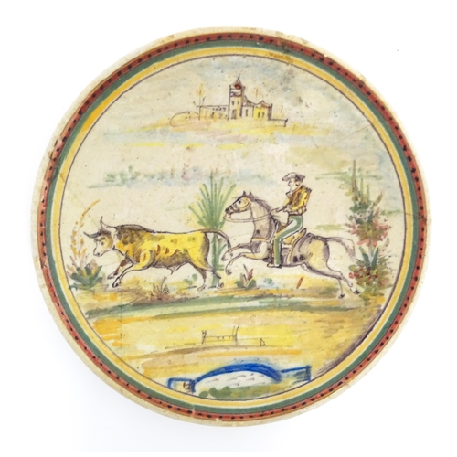 199 - Two Continental tin glazed earthenware plates one depicting a boar hunt, the other a man on horsebac... 