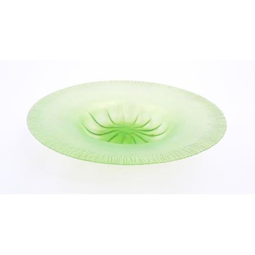 260A - A pale green lustre glass bowl with lobed centre and textured rim. Approx. 12 1/2