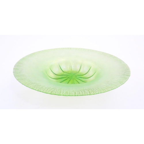 260A - A pale green lustre glass bowl with lobed centre and textured rim. Approx. 12 1/2