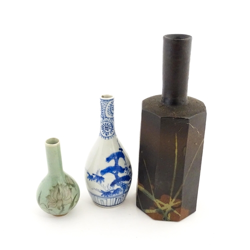 40A - A Japanese studio pottery vase with octagonal body, elongated neck and brushwork detail. Together wi... 