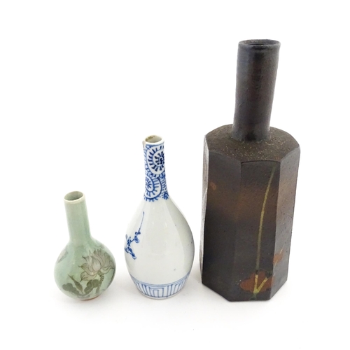 40A - A Japanese studio pottery vase with octagonal body, elongated neck and brushwork detail. Together wi... 