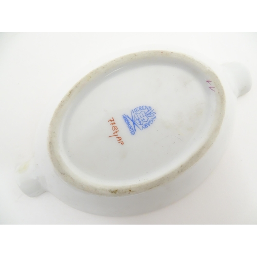 83A - A Herend porcelain ashtray of oval form decorated in the Chinese Bouquet pattern in pink. Together w... 