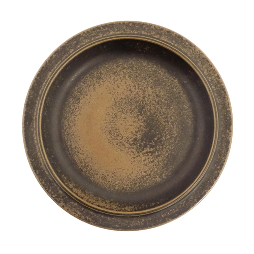 86A - A Scandinavian Ruska brown stoneware charger, marked under Arabia Finland. Together with a Swedish N... 