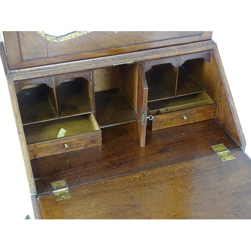 1533 - A mid 18thC mahogany bureau bookcase with a moulded cornice above a dentil frieze and shaped mirrore... 