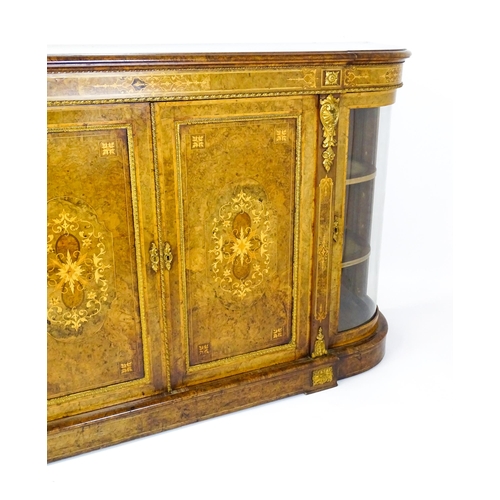 1544 - A Victorian burr walnut credenza with a bowed front and moulded top above an intricately inlaid stru... 