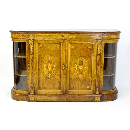 1544 - A Victorian burr walnut credenza with a bowed front and moulded top above an intricately inlaid stru... 