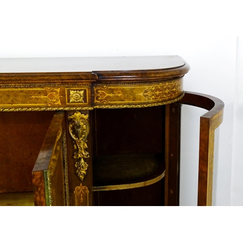 1544 - A Victorian burr walnut credenza with a bowed front and moulded top above an intricately inlaid stru... 