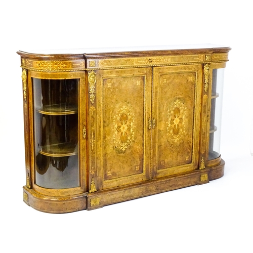 1544 - A Victorian burr walnut credenza with a bowed front and moulded top above an intricately inlaid stru... 