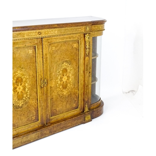 1544 - A Victorian burr walnut credenza with a bowed front and moulded top above an intricately inlaid stru... 