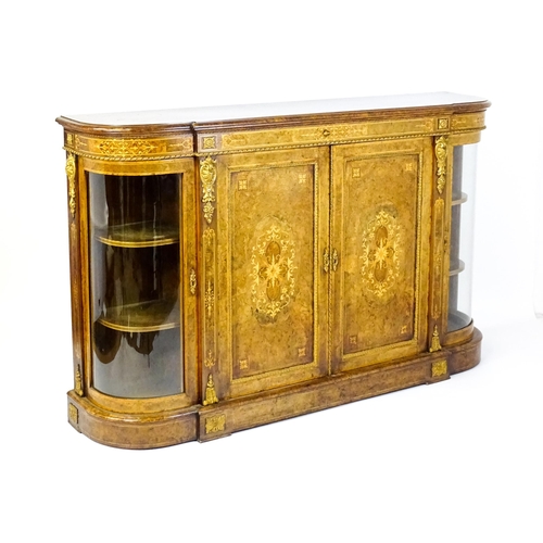 1544 - A Victorian burr walnut credenza with a bowed front and moulded top above an intricately inlaid stru... 