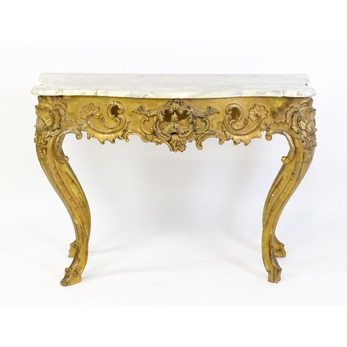 1573 - A 19thC marble topped table with a gesso and giltwood moulded base, decorated with shells, flowers, ... 