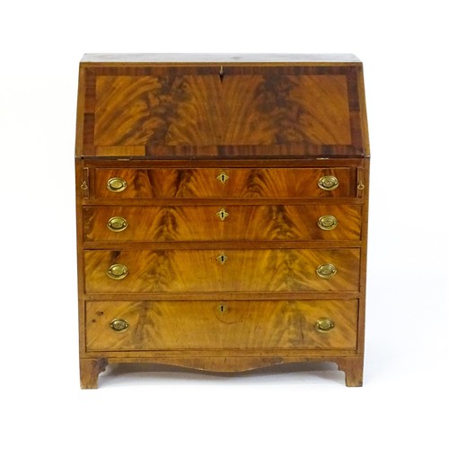 1575 - An early 19thC mahogany bureau with a fall front above four long graduated drawers with brass back p... 