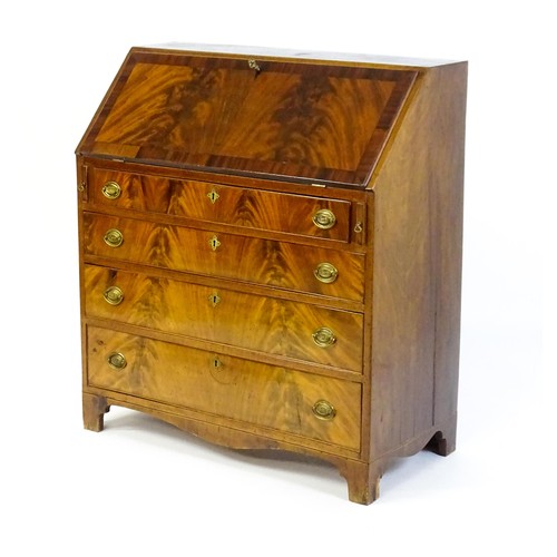 1575 - An early 19thC mahogany bureau with a fall front above four long graduated drawers with brass back p... 