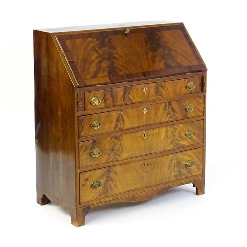 1575 - An early 19thC mahogany bureau with a fall front above four long graduated drawers with brass back p... 