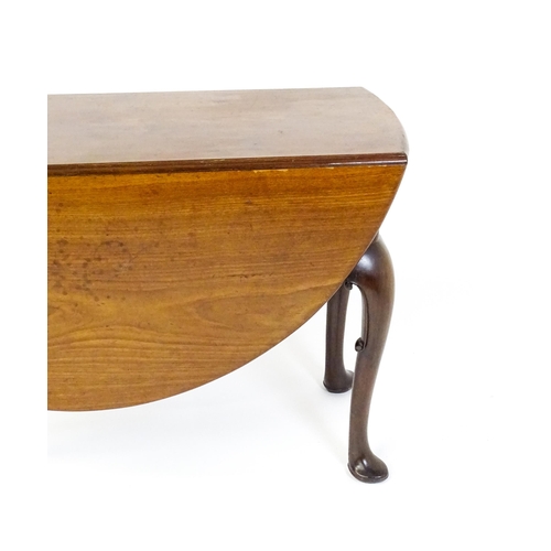 1597 - A late 18thC mahogany drop leaf table, opening to form an oval dining table and raised on four cabri... 