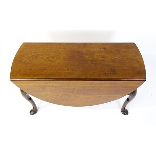 1597 - A late 18thC mahogany drop leaf table, opening to form an oval dining table and raised on four cabri... 