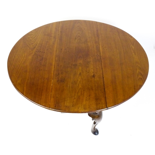 1597 - A late 18thC mahogany drop leaf table, opening to form an oval dining table and raised on four cabri... 