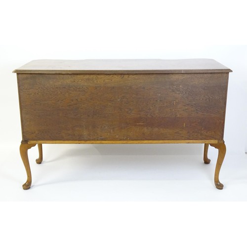 1649 - An early / mid 20thC Waring & Gillows walnut sideboard with a serpentine shaped front and a crossban... 