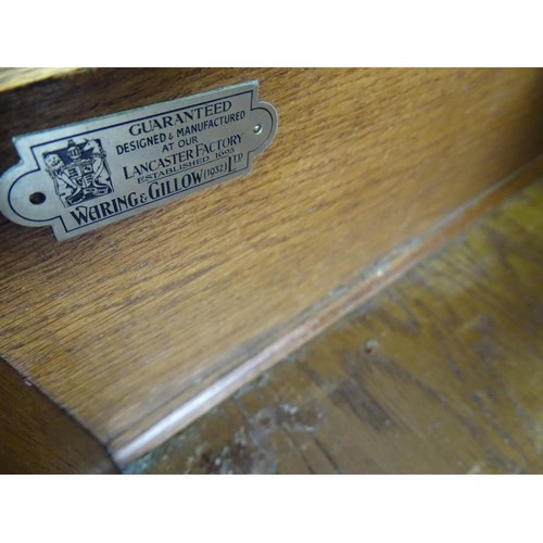 1649 - An early / mid 20thC Waring & Gillows walnut sideboard with a serpentine shaped front and a crossban... 