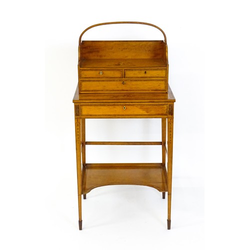 1658 - A 19thC satinwood Bonheur du jour, the removeable top having an arched carrying handle and three sma... 