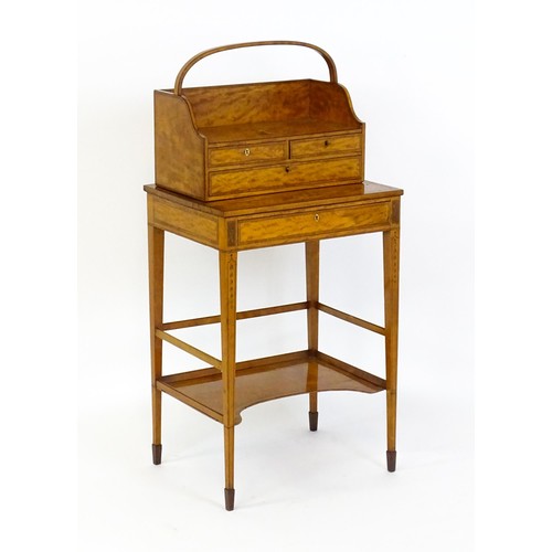 1658 - A 19thC satinwood Bonheur du jour, the removeable top having an arched carrying handle and three sma... 