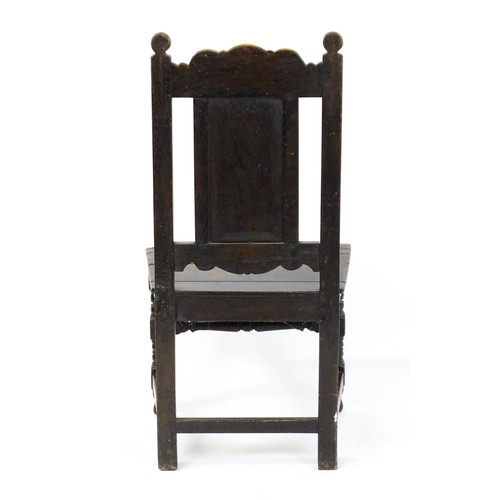 1662 - A 19thC carved oak side chair with floral carving, a planked seat and raised on block and turned leg... 