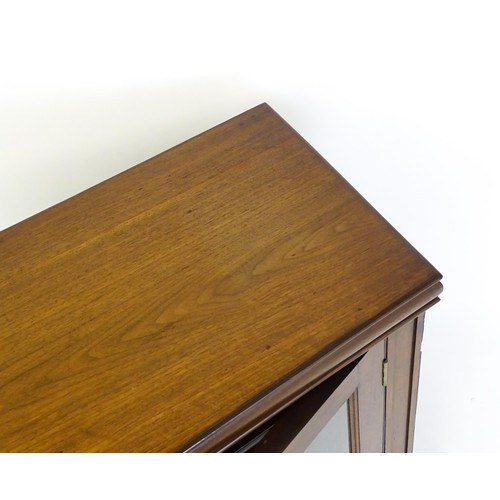 1665 - A 19thC mahogany glazed bookcase with a moulded top above two glazed doors and a stepped base. 45