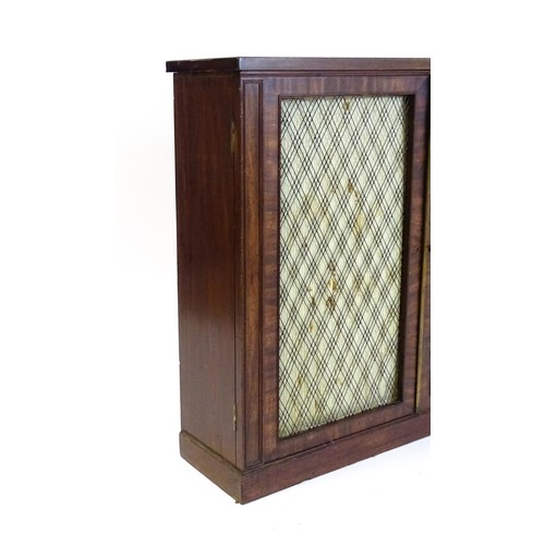 1666 - An early 19thC mahogany cabinet with a rectangular top above two grilled doors fitted with a fabric ... 