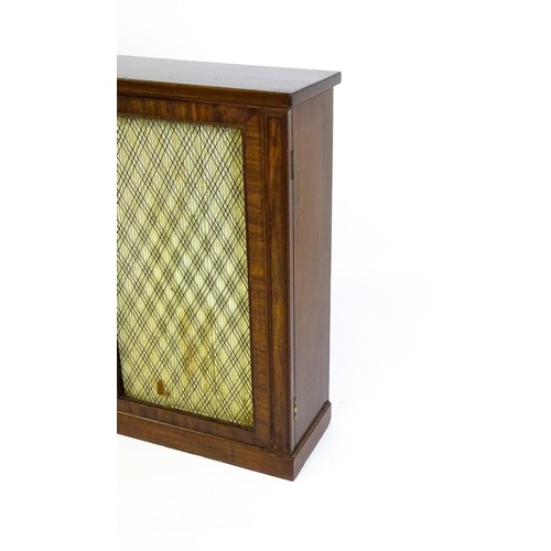 1666 - An early 19thC mahogany cabinet with a rectangular top above two grilled doors fitted with a fabric ... 