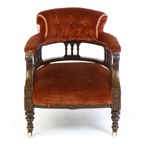 1683 - An early 20thC bow back armchair, with deep buttoned upholstery and raised on turned tapering front ... 