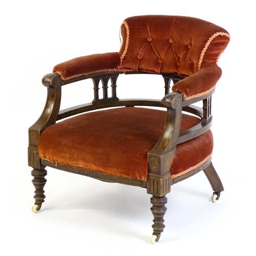 1683 - An early 20thC bow back armchair, with deep buttoned upholstery and raised on turned tapering front ... 